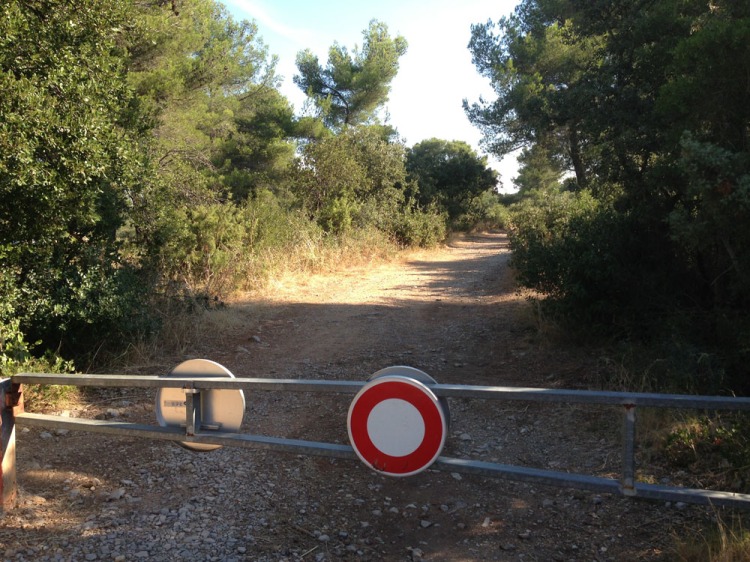 Road ends, dirt path into Foret de Keyrie